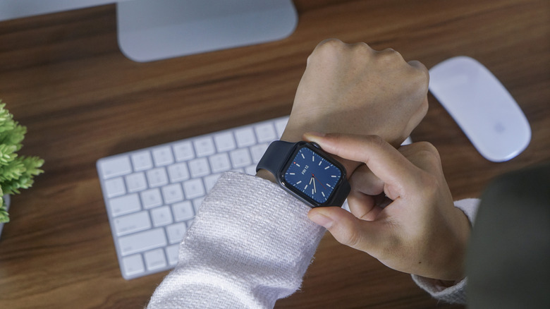 A woman using an Apple Watch