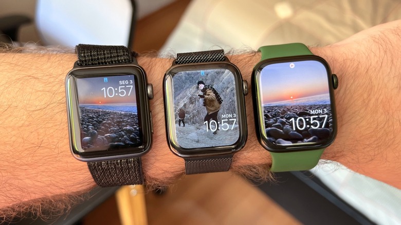 A wrist with three different Apple Watches on