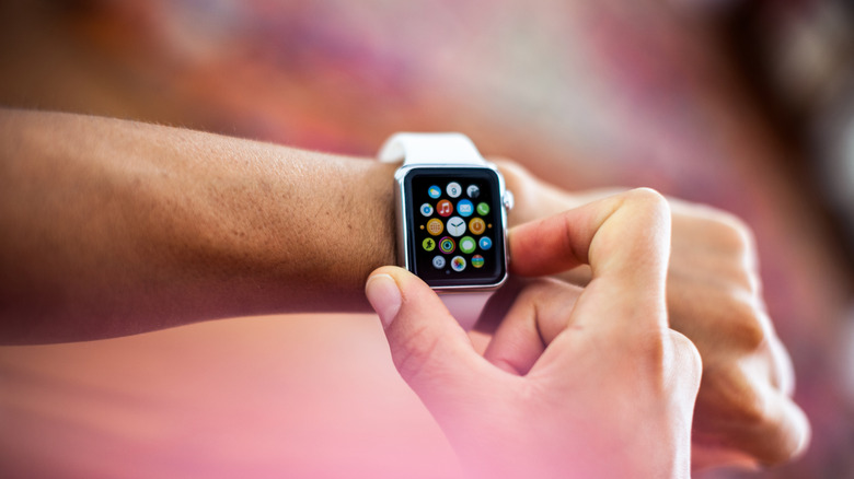Apple Watch Sport model being worn on a girl's left wrist.