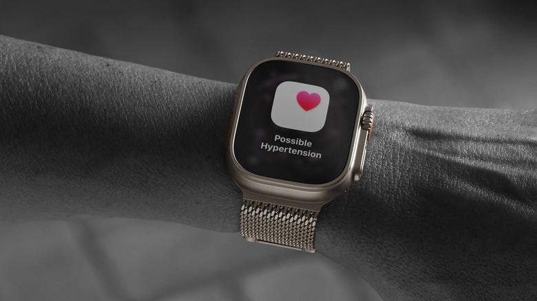 A black and white image of an arm with an Apple Watch showing possible hypertension.