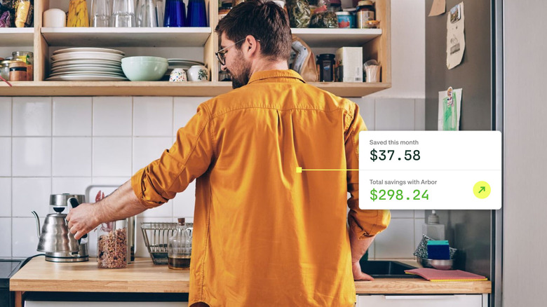 A man in a kitchen with an Arbor app overlay beside him