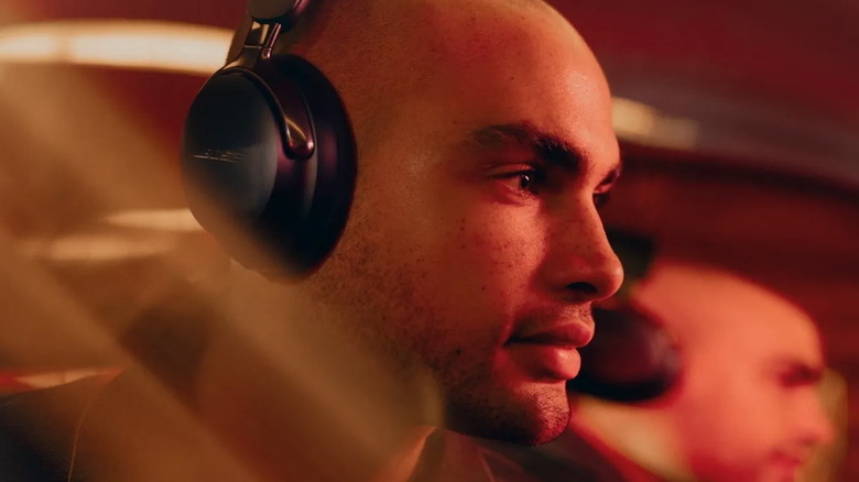 A man wearing a pair of Bose headphones.