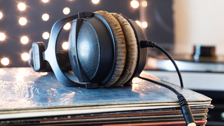 A pair of wired headphones on a stack of records