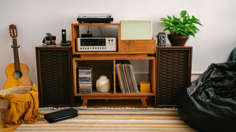 An entertainment center with a vintage sound system and accessories