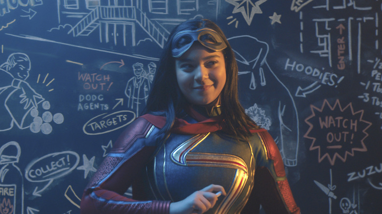 Kamala Khan (Iman Vellani) in front of a chalkboard in Ms. Marvel
