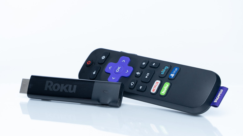 A Roku Streaming Stick and remote in front of a white background.