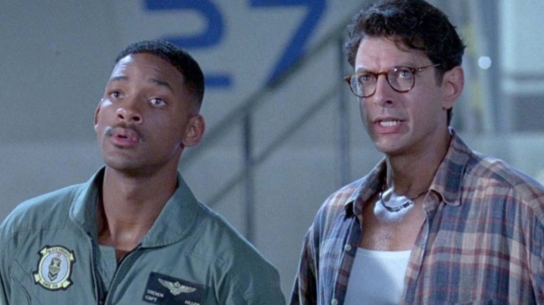 Will Smith as Captain Steven Hiller and Jeff Goldblum as David Levinson stood together looking at something in "Independence Day."