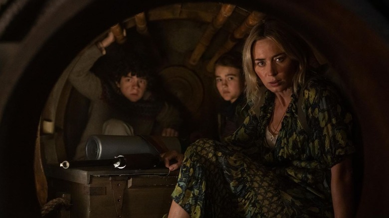 A Quiet Place Part II still with the main characters hiding in a small vault.