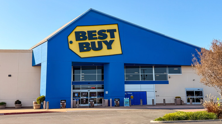 Best Buy store front with yellow logo against blue paint
