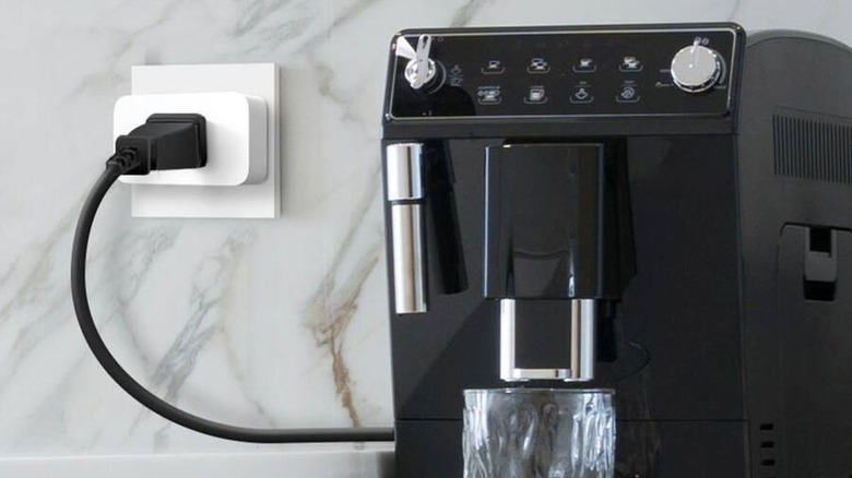 A countertop espresso maker is plugged into the TP-Link Tapo Smart Plug.