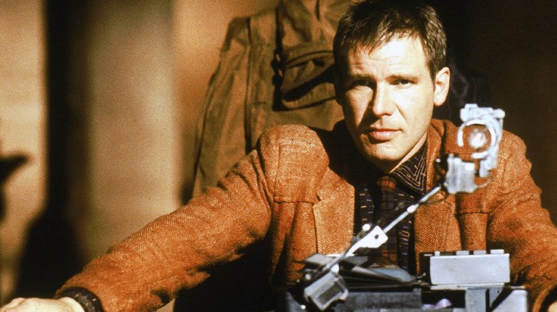 Deckard (Harrison Ford) sat at a table with a Turing test in Blade Runner