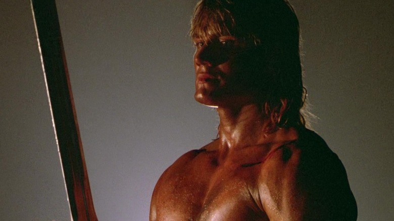 Dolph Lundgren as He-Man in Masters of the Universe holding a sword