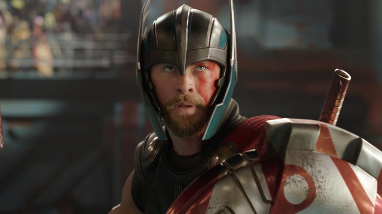 Thor (Chris Hemsworth) in a helmet with a shield in Thor: Ragnarok