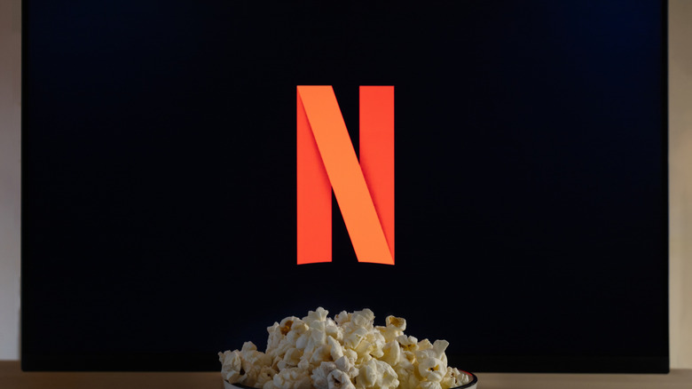 Netflix logo on a TV screen with a bowl of popcorn in front