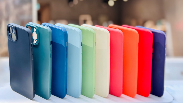 a lineup of phone cases standing upright on a table.
