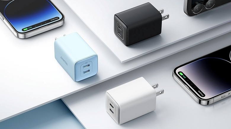 Anker 523 charger in three colors surrounded by Apple iPhones