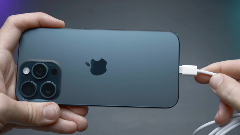 Someone plugging in an iPhone