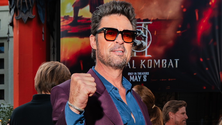 Karl Urban with his fist raised