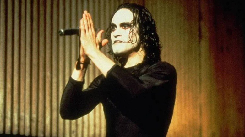 Brandon Lee holding a knife as Eric Draven in The Crow