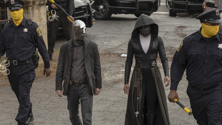 Sister Night (Regina King) and Looking Glass (Tim Blake Nelson) walking in Watchmen