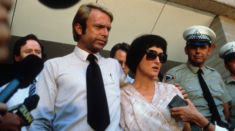 Michael and Lindy surrounded by reporters in "Evil Angels."