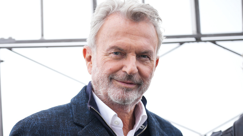 Sam Neill smiling on top of the Empire State Building in New York City in 2024.