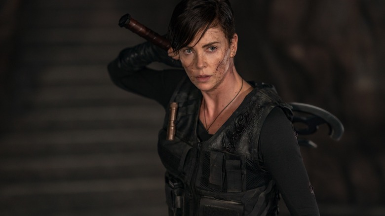 Charlize Theron as Andy in The Old Guard holding an axe