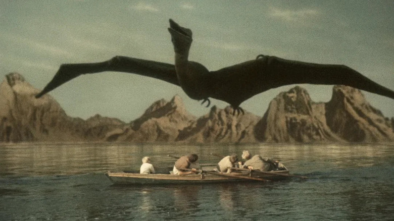 A Pteranodon flying over four teens in a boat in "Journey to the Beginning of Time."