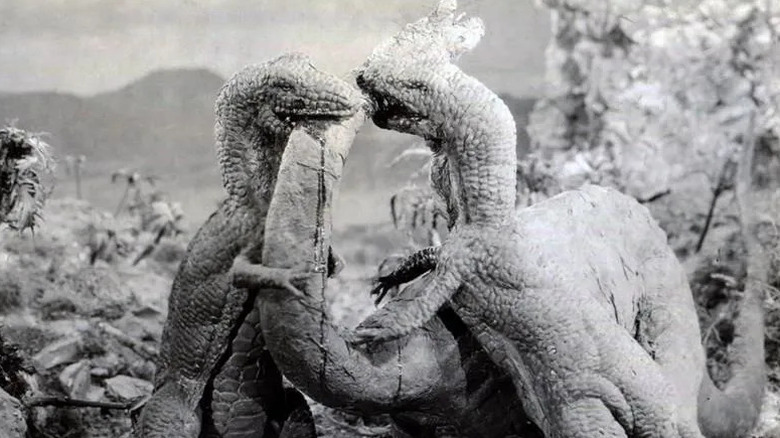 Two Tyrannosauruses attacking a Brontosaurus in "The Lost World."