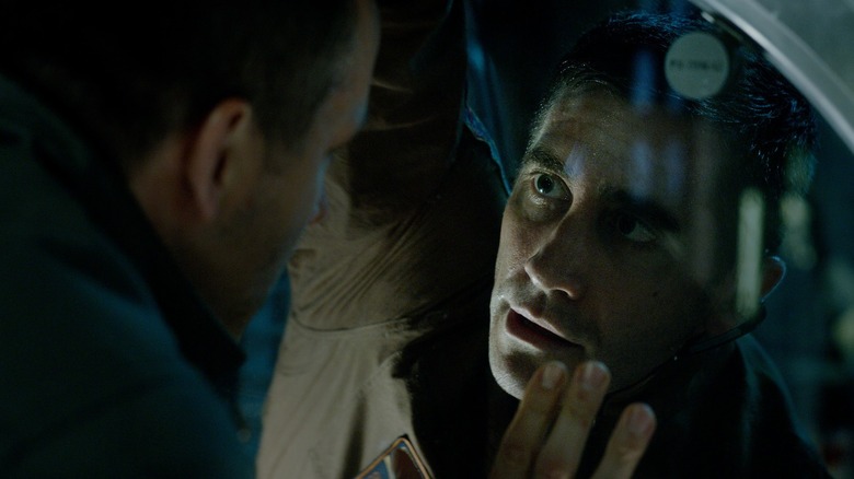 Jake Gyllenhaal looking at someone in Life