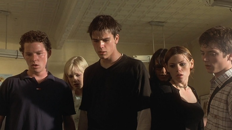 The cast of The Faculty looking down at something