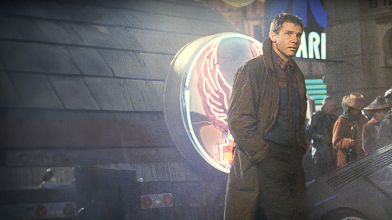 Deckard from Blade runner played by Harrison Ford walking in the city