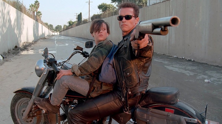 John Connor (Edward Furlong) on a motorcycle with the T-800 (Arnold Schwarzenegger) in Terminator 2: Judgment Day