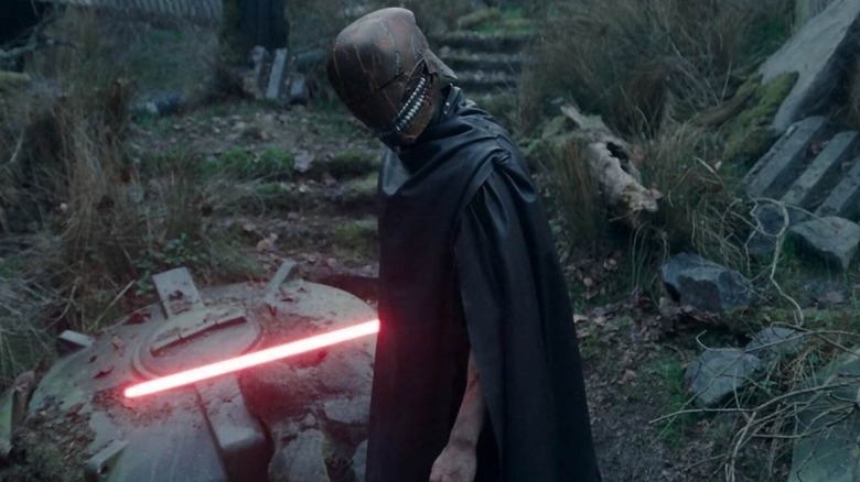 Qimir holding a lightsaber in The Acolyte