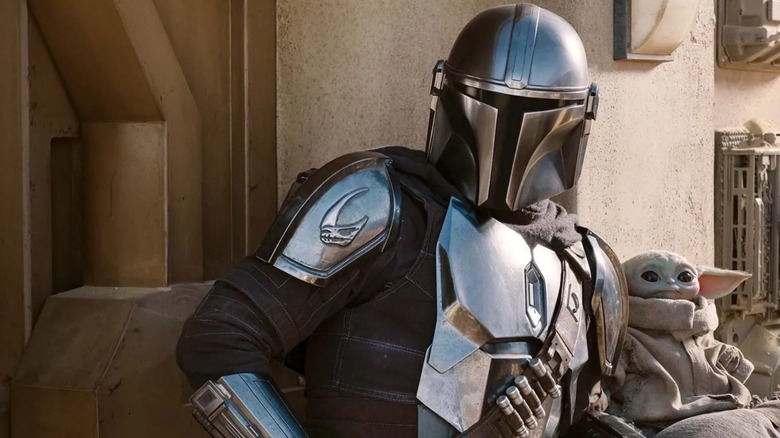 The Mandalorian and Grogu sitting down in The Mandalorian
