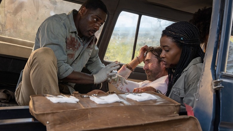 Idris Elba, Sharlto Copley, and Iyana Halley sat in a truck in Beast