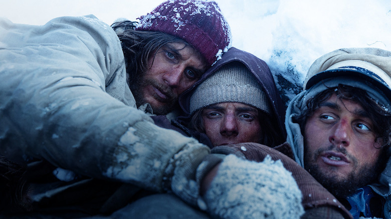 The cast of Society of the Snow surviving in the snow