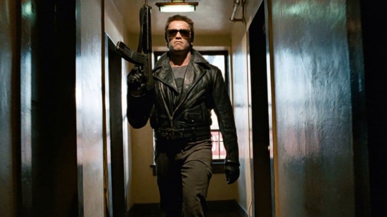 The Terminator (Arnold Schwarzenegger) walking down the hallway armed in The Terminator