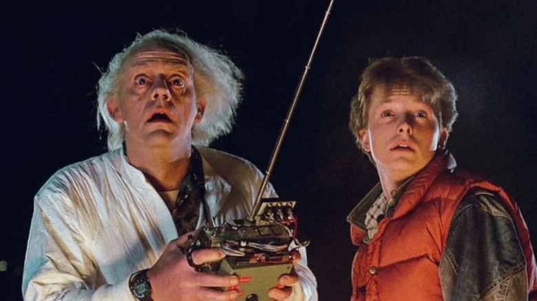 Doc Brown and Marty looking forward with Doc holding a remote control in Back to the Future