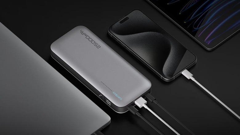 CukTech 25,000mAh power bank charging an iPhone and a laptop