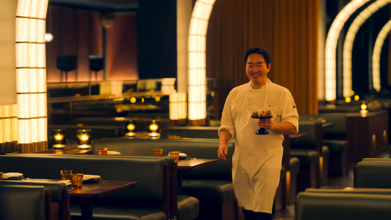 Coqodaq Executive Chef SK Kim presenting a dish in Knife Edge: Chasing Michelin Stars