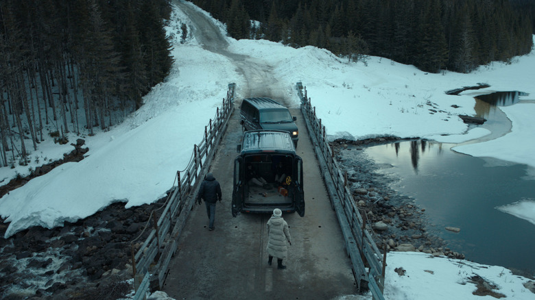 Trucks on a bridge in the snow in The Last Frontier on Apple TV+