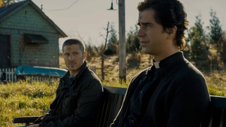 Riley Flynn (Zach Gilford) and Father Paul Hill (Hamish Linklater) sat together in Midnight Mass