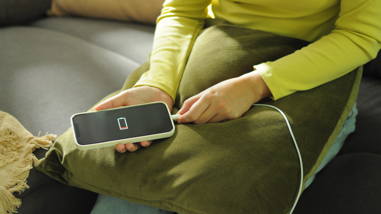 A person charging a low battery iPhone