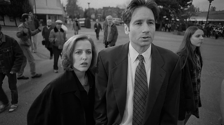 Scully and Mulder looking curiously on the street