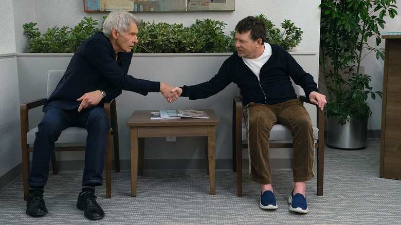 Harrison Ford and Michael J. Fox in a doctor's waiting room shaking hands in Shrinking.