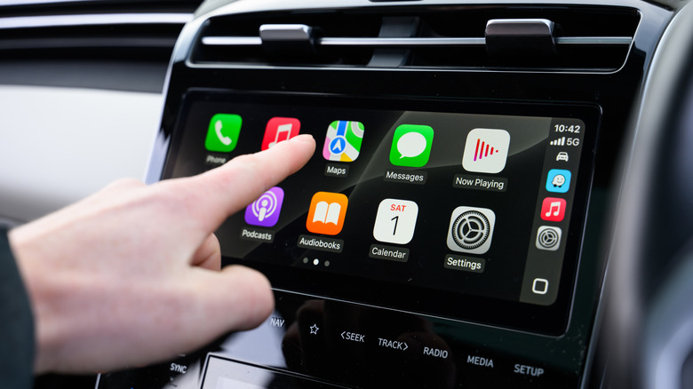 Hand Interacting with Apple CarPlay in a vehicle