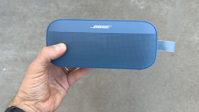 Holding a Bose Bluetooth speaker