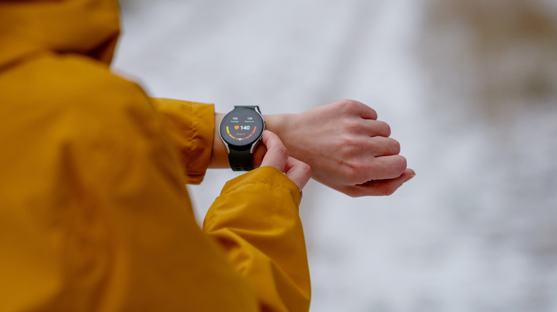 Over the shoulder view of a fitness tracker on a wrist