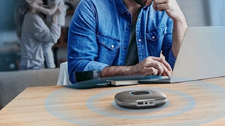 Anker PowerConf speakerphone on table working from home.